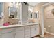 Bright bathroom featuring white vanity, drawers, and mirrors for ample storage at 11820 Stone Pine St, Riverview, FL 33569