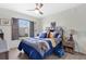 Bright bedroom with a window view, ceiling fan, and stylish decor at 11820 Stone Pine St, Riverview, FL 33569