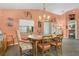 Traditional dining room features chandelier, window, and view to another room at 11820 Stone Pine St, Riverview, FL 33569
