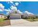 Charming single-story home boasts a two-car garage, well-kept lawn, and tropical landscaping in a desirable neighborhood at 11820 Stone Pine St, Riverview, FL 33569