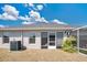 Exterior view featuring a patio door and windows and an air conditioning unit at 11820 Stone Pine St, Riverview, FL 33569