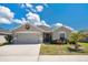 Charming single-story home boasts a two-car garage, well-kept lawn, and tropical landscaping in a desirable neighborhood at 11820 Stone Pine St, Riverview, FL 33569