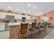 Open kitchen featuring white cabinets, stainless steel appliances, marble counters and an island with barstool seating at 11820 Stone Pine St, Riverview, FL 33569