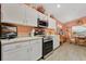 Well-lit kitchen featuring white cabinets, stainless steel appliances, marble counters and an adjacent dining area at 11820 Stone Pine St, Riverview, FL 33569