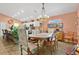 Well-lit open concept kitchen with white cabinets, stainless appliances, marble counters, and a dining area at 11820 Stone Pine St, Riverview, FL 33569