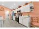 Well-lit kitchen featuring white cabinets, stainless steel appliances, marble counters and an adjacent dining area at 11820 Stone Pine St, Riverview, FL 33569