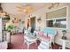 Charming covered patio with wicker furniture, ceiling fan, and colorful decorations at 11820 Stone Pine St, Riverview, FL 33569