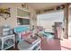 Cozy covered patio with seating, grill, and decorative wall art at 11820 Stone Pine St, Riverview, FL 33569