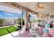 Enclosed patio with ample seating, ceiling fan, and view to grassy fenced yard at 11820 Stone Pine St, Riverview, FL 33569