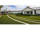 Relax by the community pool featuring turf putting green, lounge chairs, umbrellas, and a cabana area at 17220 Savory Mist Cir, Bradenton, FL 34211