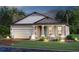 Inviting single-Gathering home featuring a two-car garage, covered entryway, and beautifully landscaped front yard at 17220 Savory Mist Cir, Bradenton, FL 34211