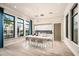 A modern kitchen area with a large island, seating, sleek appliances, and ample natural light at 17220 Savory Mist Cir, Bradenton, FL 34211