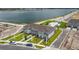 A bird's eye view of a modern townhouse complex near a scenic lake at 1755 Spreader Ln, Sarasota, FL 34240