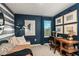 This bedroom features blue walls, artwork, and a desk area at 1755 Spreader Ln, Sarasota, FL 34240