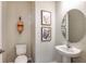 Chic powder room with unique wallpaper, decorative mirror, and modern fixtures at 1755 Spreader Ln, Sarasota, FL 34240