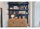 Stylish shelving area with decorative items and a woven accent cabinet at 1755 Spreader Ln, Sarasota, FL 34240