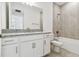 Clean bathroom with granite countertops, white cabinets, and tile flooring at 18032 Cherished Loop, Bradenton, FL 34211