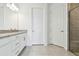 Bathroom featuring granite countertop, white cabinets, and tiled shower at 18032 Cherished Loop, Bradenton, FL 34211