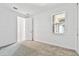 Bright bedroom with neutral carpet and a sunlit window at 18032 Cherished Loop, Bradenton, FL 34211