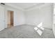 Sunlit bedroom boasts neutral carpet, tray ceiling, and ample natural light at 18032 Cherished Loop, Bradenton, FL 34211