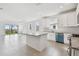 A well-lit kitchen featuring white cabinets, stainless steel appliances, granite counters and a view of the lanai at 18032 Cherished Loop, Bradenton, FL 34211