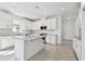 A modern kitchen featuring white cabinets, stainless steel appliances, granite counters and tile flooring at 18032 Cherished Loop, Bradenton, FL 34211