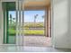A screened lanai with brick pavers offers a tranquil view of the outdoors with palm trees at 18032 Cherished Loop, Bradenton, FL 34211