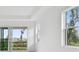 Bright interior view to a screened patio with palm trees and landscaping at 18032 Cherished Loop, Bradenton, FL 34211