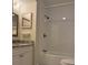 Bathroom features new white subway tile shower, updated vanity with granite top and framed mirror at 3102 W Horatio St # 12, Tampa, FL 33609