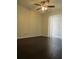 Bedroom featuring dark laminate wood floors, neutral paint, a ceiling fan, and sliding glass doors at 3102 W Horatio St # 12, Tampa, FL 33609