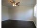 Well-lit bedroom with dark laminate floors and a ceiling fan at 3102 W Horatio St # 12, Tampa, FL 33609