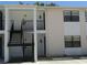 Multi-level condo building featuring stairs, railings, and neutral siding at 3102 W Horatio St # 12, Tampa, FL 33609
