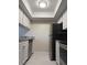 Galley kitchen features sleek white cabinetry and stainless steel appliances at 3102 W Horatio St # 12, Tampa, FL 33609