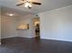 Spacious living room with dark laminate floors and a ceiling fan at 3102 W Horatio St # 12, Tampa, FL 33609