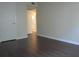 A living room with hardwood floors showing the entrance to the kitchen at 3102 W Horatio St # 12, Tampa, FL 33609