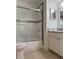 Bathroom featuring a tub and shower combo with a sliding glass door and vanity with marble countertop at 3102 W Horatio St # 21, Tampa, FL 33609