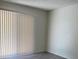 Bedroom showcasing laminate flooring, neutral paint, and a large window with vertical blinds at 3102 W Horatio St # 21, Tampa, FL 33609
