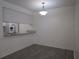 Bright dining area featuring sleek flooring, a view to the kitchen, and modern lighting at 3102 W Horatio St # 21, Tampa, FL 33609