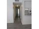 Hallway view, showcasing modern flooring, leading to the kitchen with an open pass-through and ample lighting at 3102 W Horatio St # 21, Tampa, FL 33609