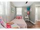 Light-filled bedroom with hardwood floors, natural light, and neutral wall color at 3703 Cooper Rd, Plant City, FL 33565