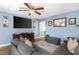 Comfortable living room with ceiling fan and a large TV above an entertainment center at 3703 Cooper Rd, Plant City, FL 33565