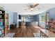 Spacious living room with hardwood floors, lots of natural light, and ceiling fan at 3703 Cooper Rd, Plant City, FL 33565