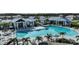 Aerial shot of a community pool surrounded by palm trees and lounge chairs, perfect for relaxation and recreation at 17212 Savory Mist Cir, Lakewood Ranch, FL 34211