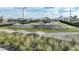 Community pump track for biking and skateboarding with manicured landscaping and bordering trees at 17212 Savory Mist Cir, Lakewood Ranch, FL 34211