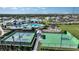 Aerial view of a community with tennis courts, basketball court, pool, playground, and pump track at 17212 Savory Mist Cir, Lakewood Ranch, FL 34211