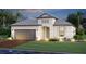 Beautifully landscaped single-story home featuring a two-car garage and neutral color palette at 17216 Savory Mist Cir, Bradenton, FL 34211