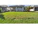 The backyard features a well-maintained lawn, covered patio and lake views at 17245 Savory Mist Cir, Bradenton, FL 34211