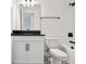 Bathroom featuring vanity, black countertop, sink, toilet and black and white tile floor at 17245 Savory Mist Cir, Bradenton, FL 34211