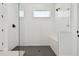 Modern bathroom featuring a glass shower with white subway tile and a dark floor at 17245 Savory Mist Cir, Bradenton, FL 34211