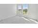 This bedroom has plush carpeting, bright white walls and trim, and two windows providing ample natural light at 17245 Savory Mist Cir, Bradenton, FL 34211
